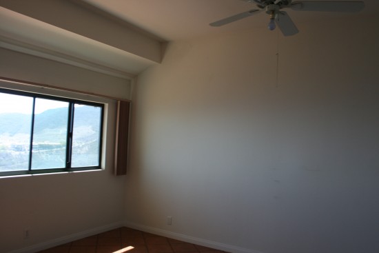 master bedroom.  All of our bedrooms are going to be light gray.  I'm finally going to get rid of the hand-me-down valances and bedspread that were never really my style and plan to embrace a navy/yellow/gray color scheme.  Even plotting to repaint our furniture!  Curtain ideas here?  We'll probably put a desk under this window.