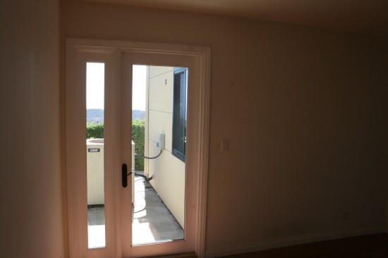 Tommy's room.  All three of the downstairs bedrooms have doors leading out to our tiny patio which is at the edge of the mountain.  Will have to figure out how to do child-proof locks on all of those.  What am I going to do with this tiny narrow window and glass door?